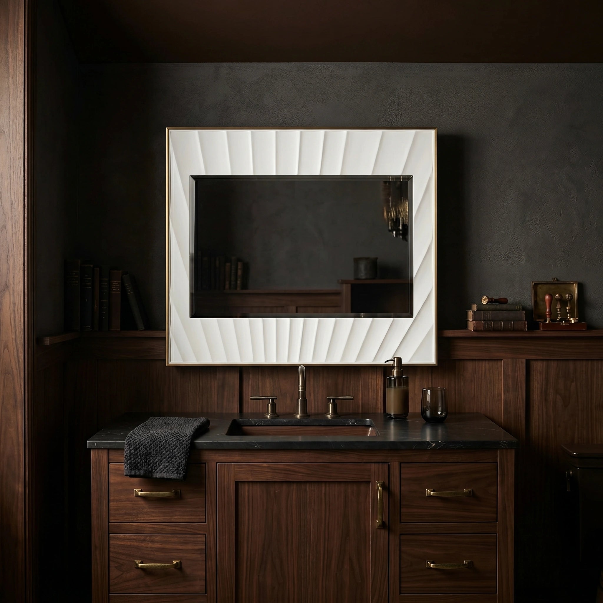 Bathroom vanity with wooden cabinets, black countertop, and decorative mirror.