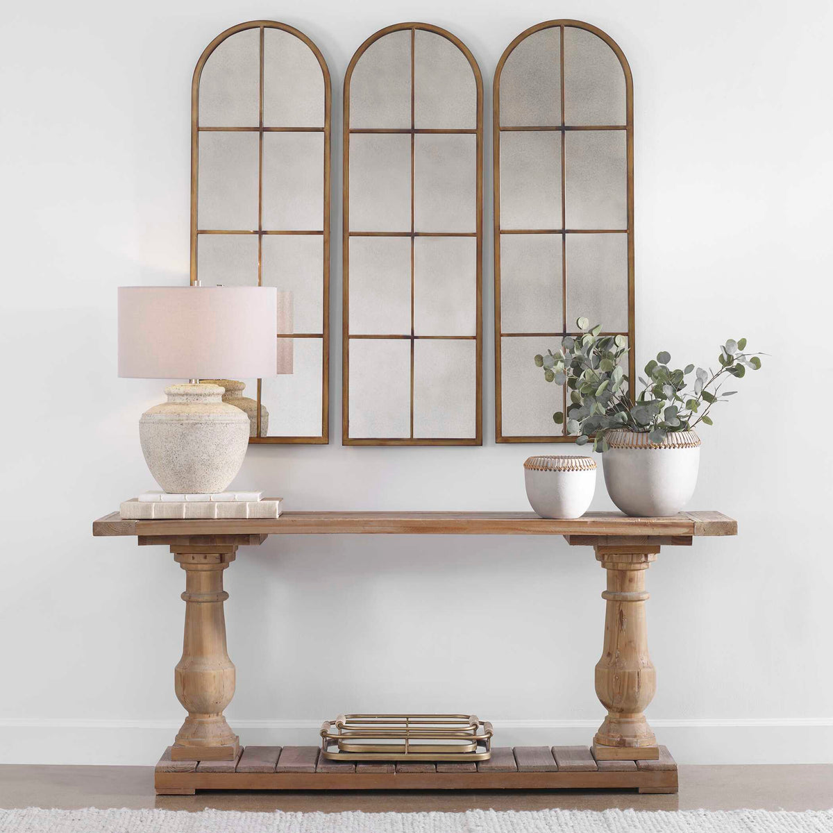 Uttermost 13463 P Amiel arched mirror, three shown above an entry table with a lamp