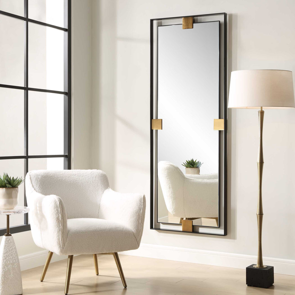 Uttermost 09998 Cornerstone oversized mirror in a living room beside a boucle accent chair and floor lamp