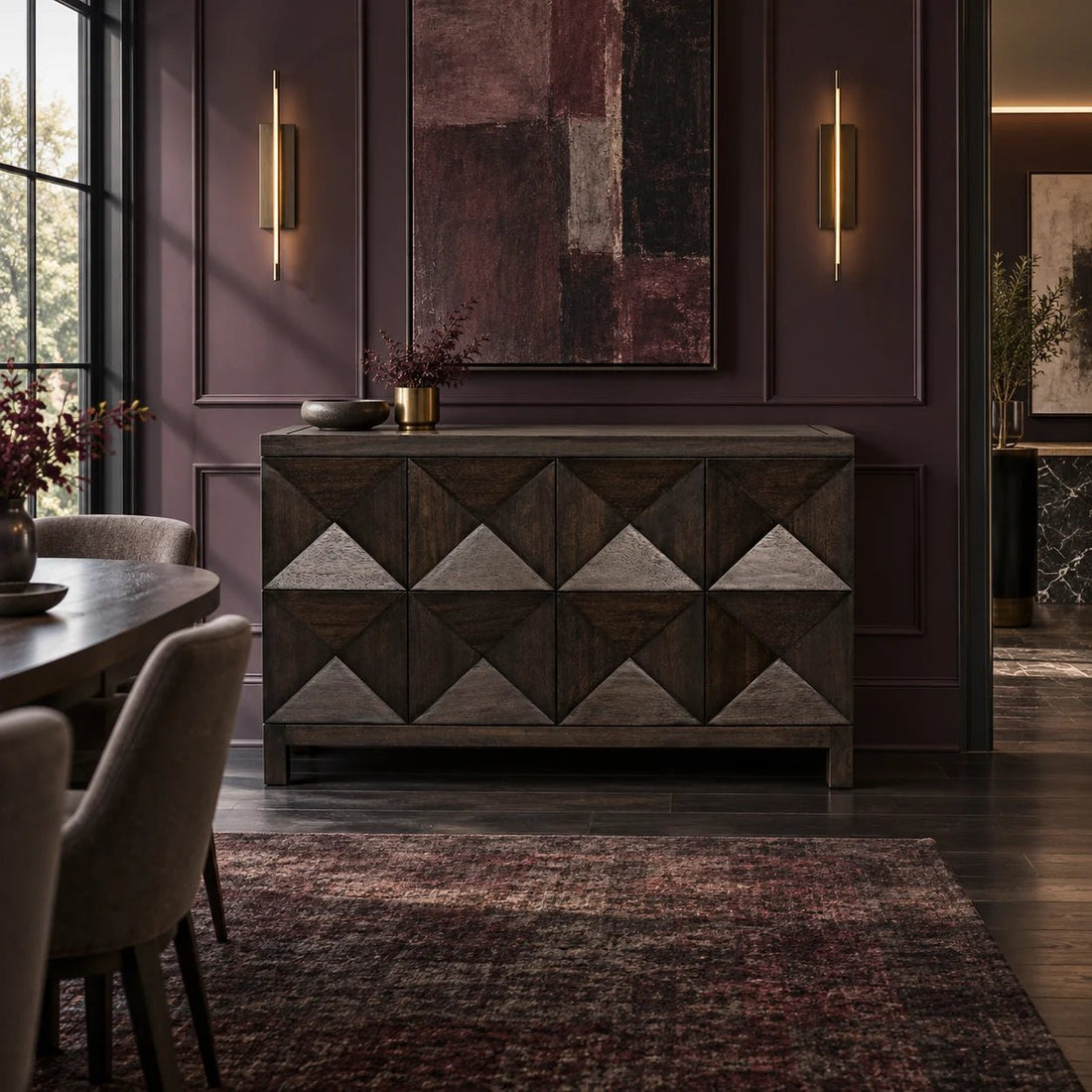 51.5" Ebony Walnut Geometric Carved 2 Door Sideboard. Two geometrically carved doors open via hidden push latch to reveal one large interior cupboard, with one removable shelf, in this handcrafted and finished walnut sideboard. Shown in a dining room.