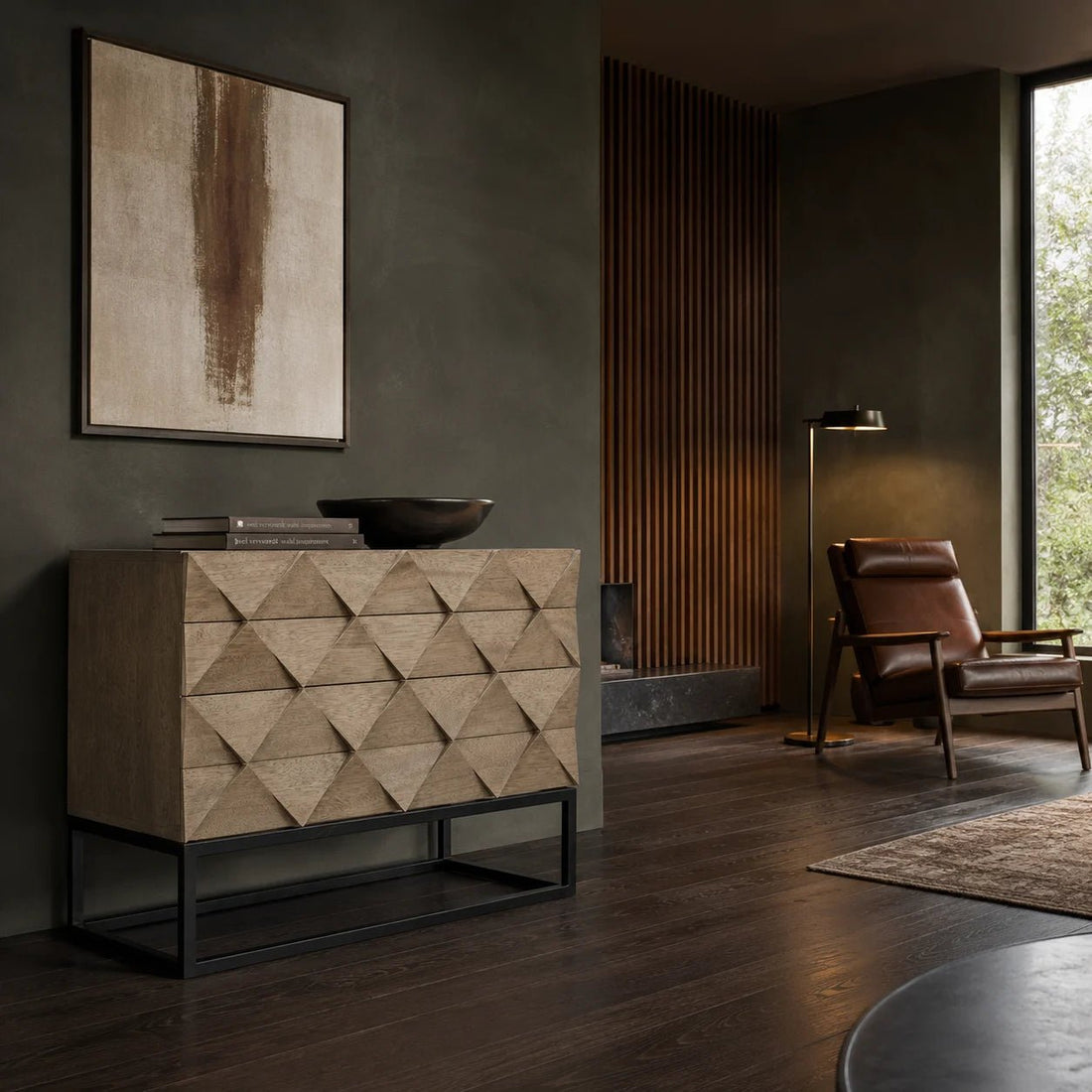 Draco Sideboard with Iron Stand in Washed Walnut w/ Matte Black Legs by Noir (GCON301WAW). Each of this refined washed walnut sideboard's three drawers are beautifully embellished with a repeating hand-carved pattern. Shown in a dining room.