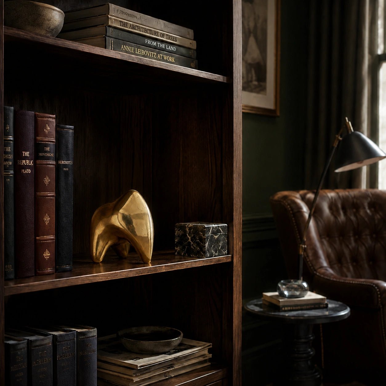 Wooden bookshelf with books and decorative items in a dimly lit room.