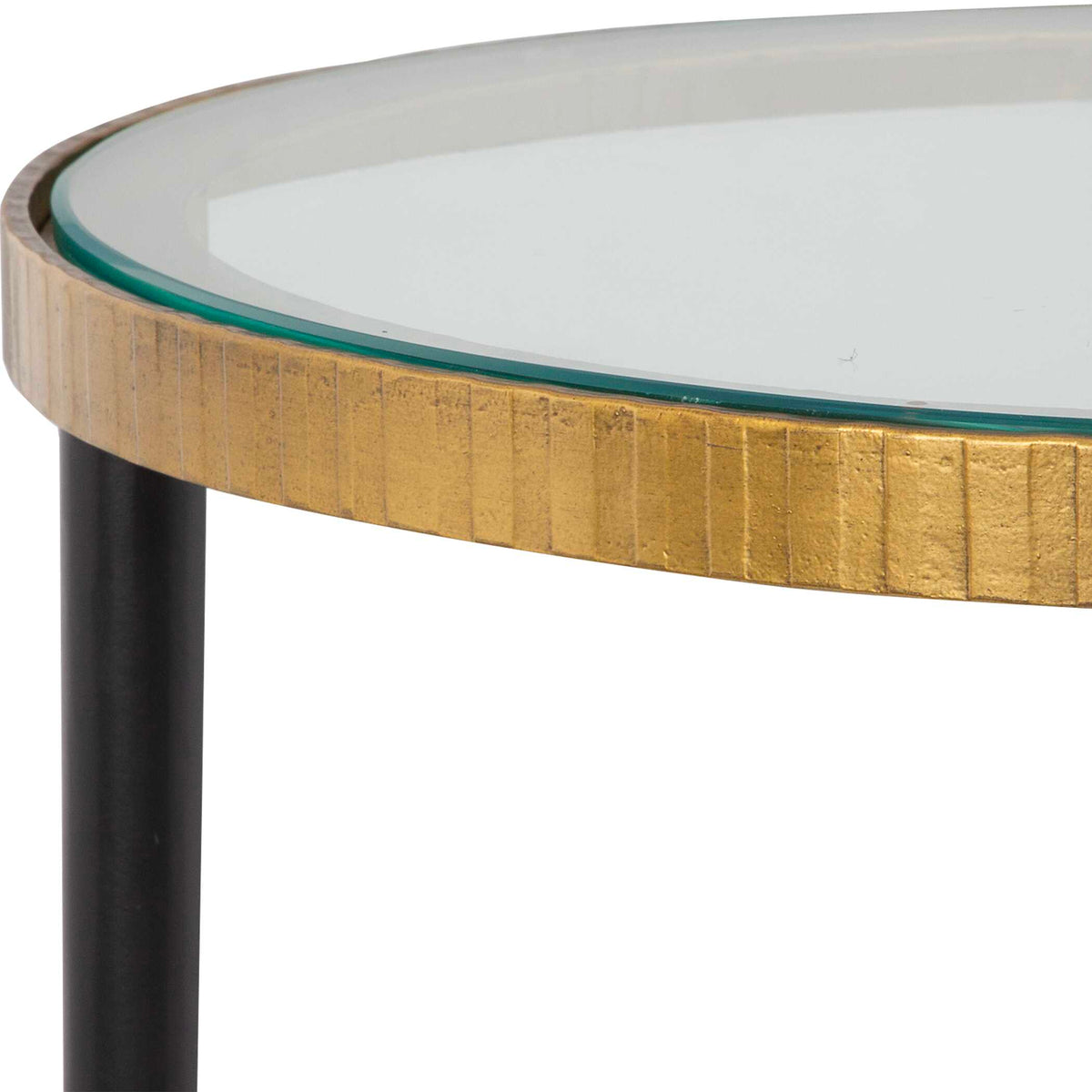 Close-up of the texture rimmed top in antique gold around clear glass on a small round table