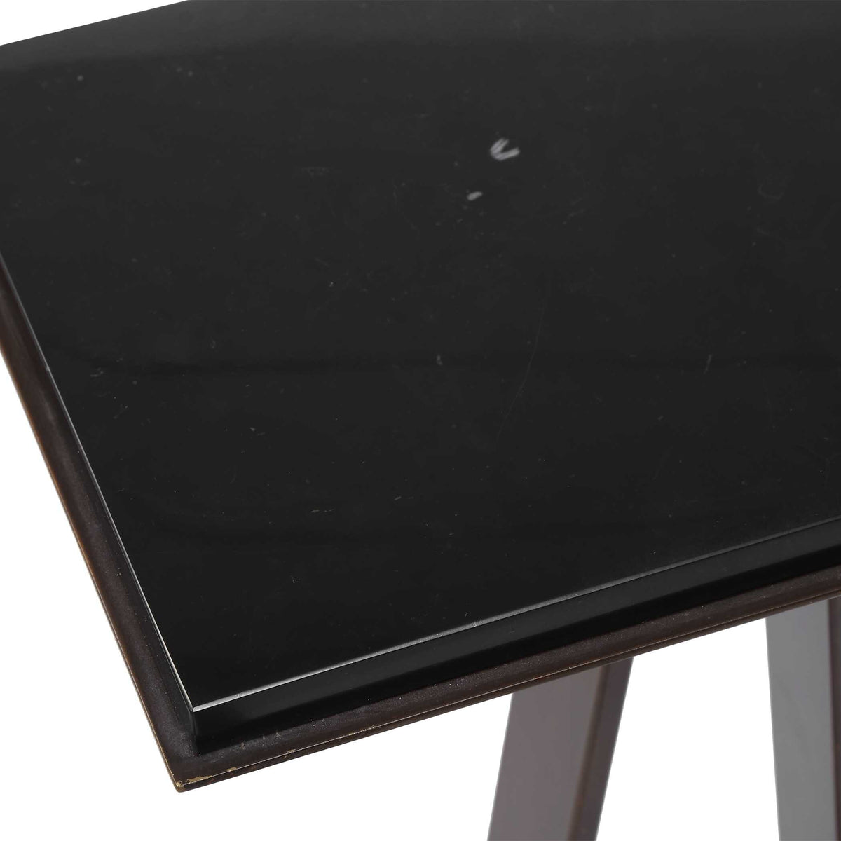 Corner detail of a matching marble top set into a dark bronze edge, Art Deco style