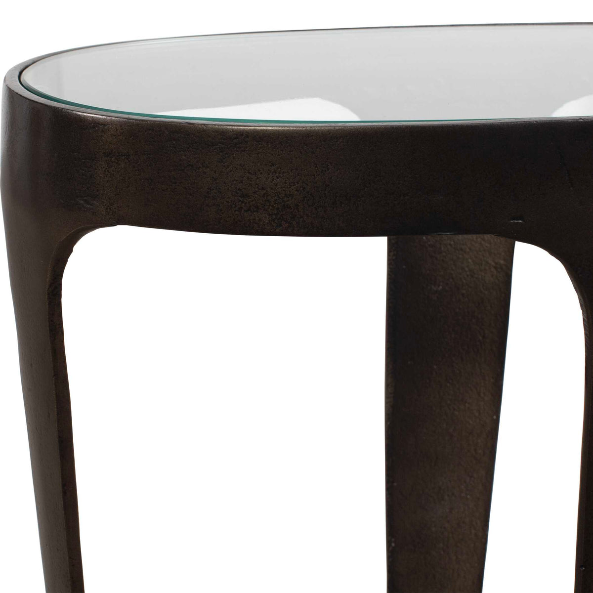 Close-up of the inset glass top on a cast aluminum side table in dark bronze, Dark Academia look