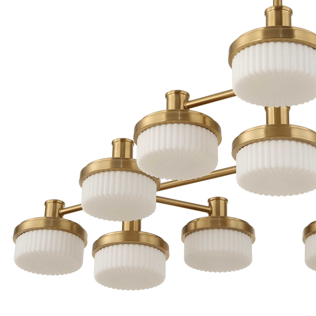 Cluster of white opal shades on warm brass arms, close crop