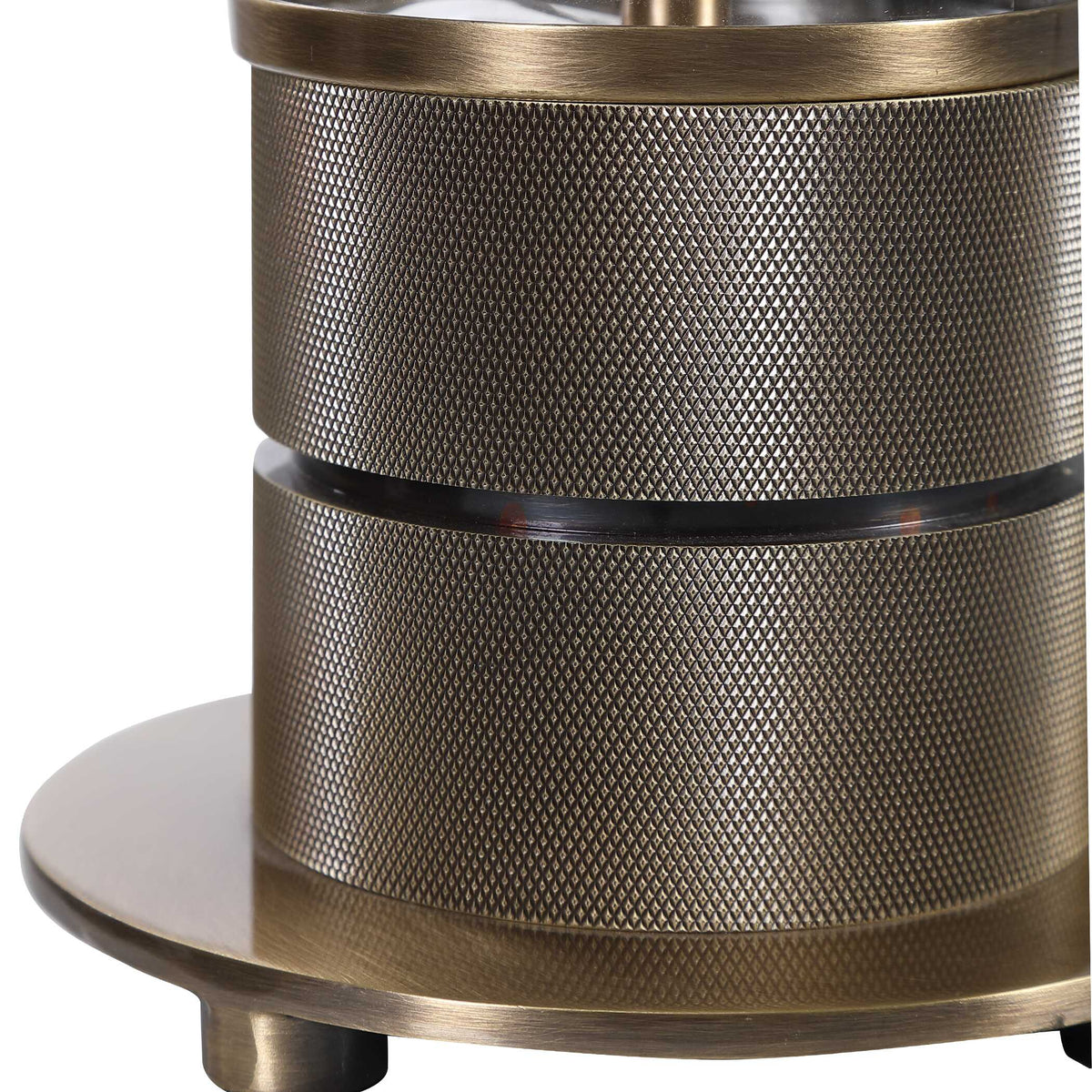 Close-up of the heavy textured iron base bands in antiqued brass plating on a glass nightstand lamp