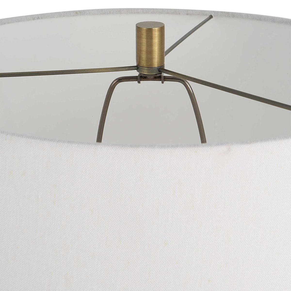 Brushed brass finial and shade spider inside the white hardback shade of the cast iron reading lamp