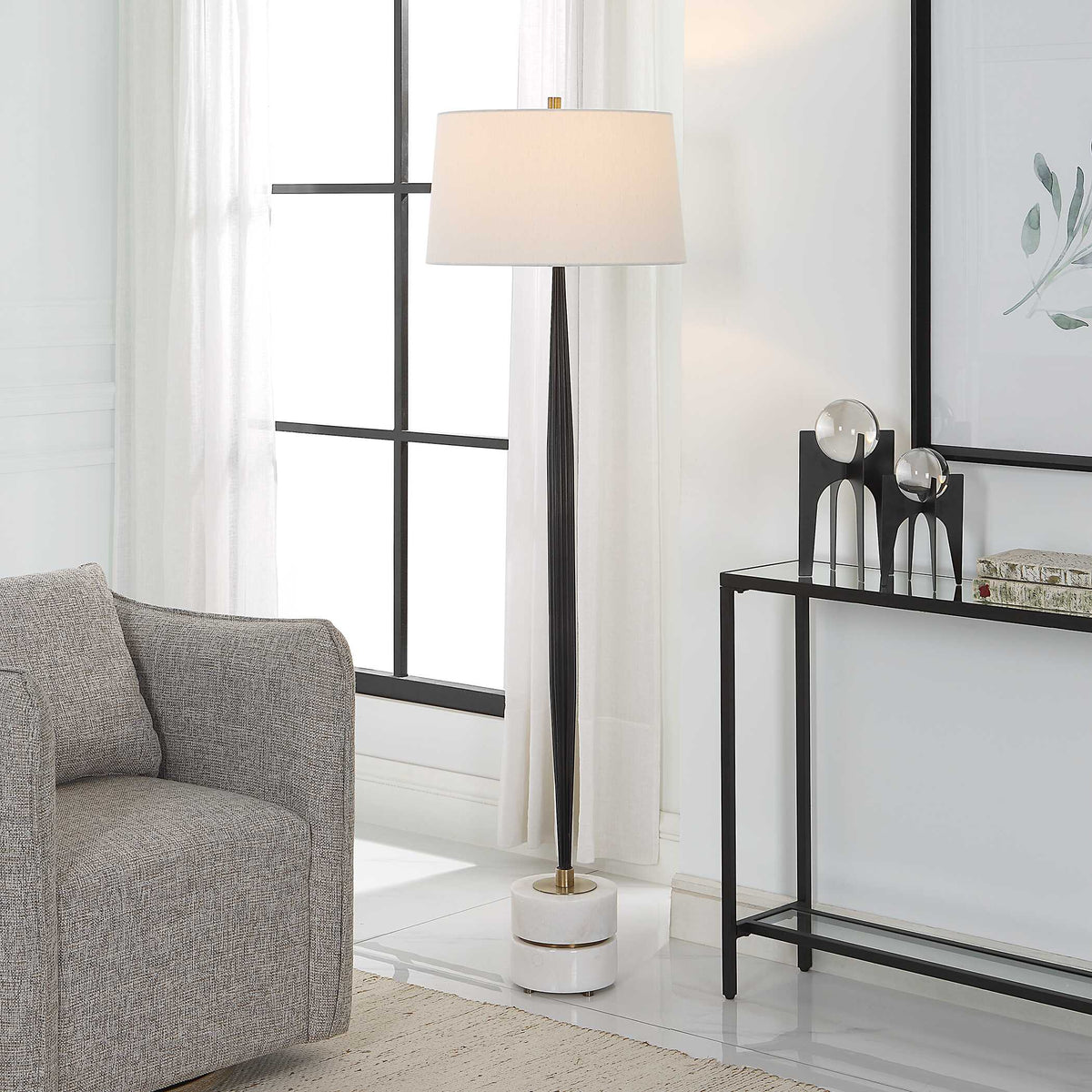 Reading lamp with channeled iron column and white marble base, light off, beside a mirrored console table