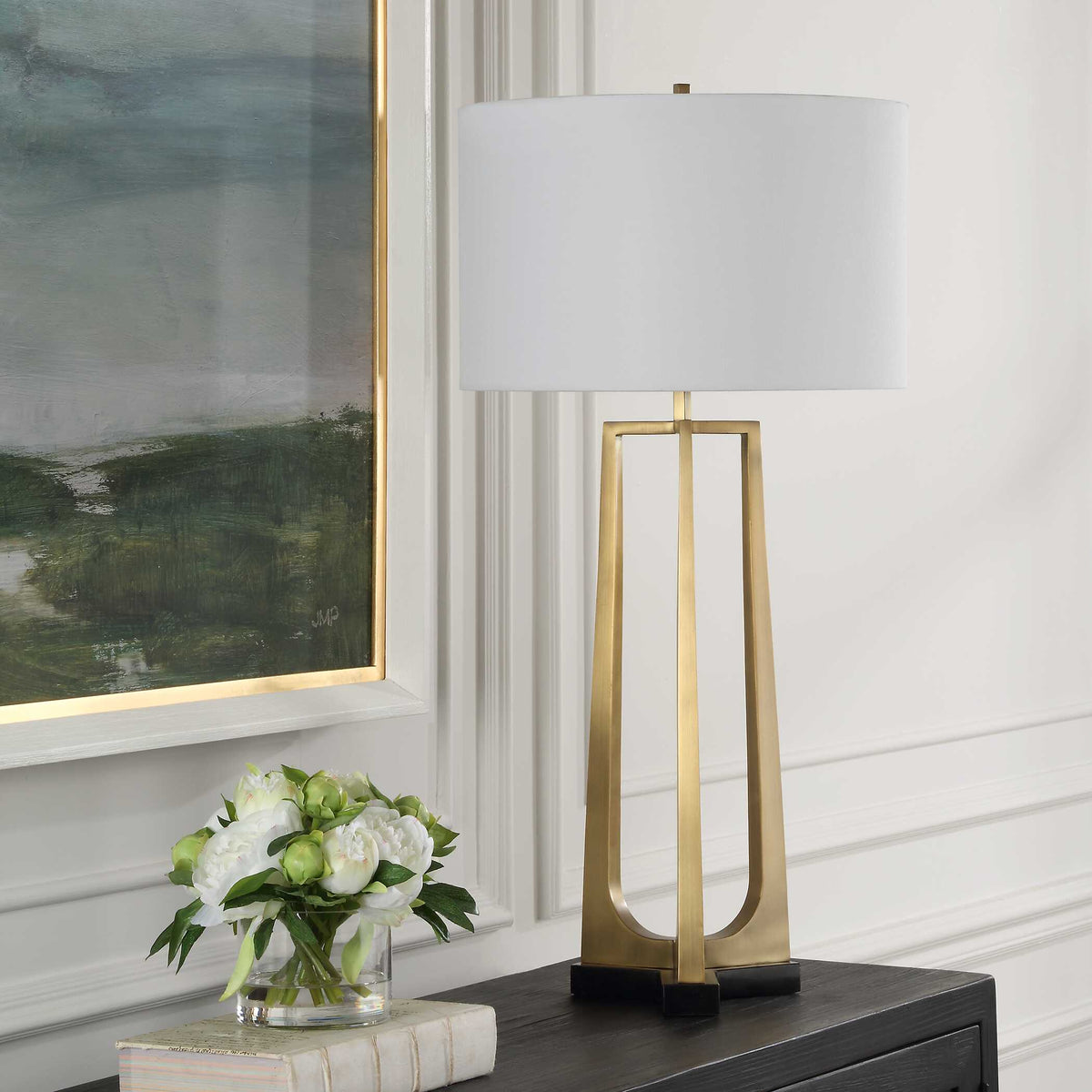 Art Deco living room lamp with three tapered plated antique brass legs on a thick black marble foot