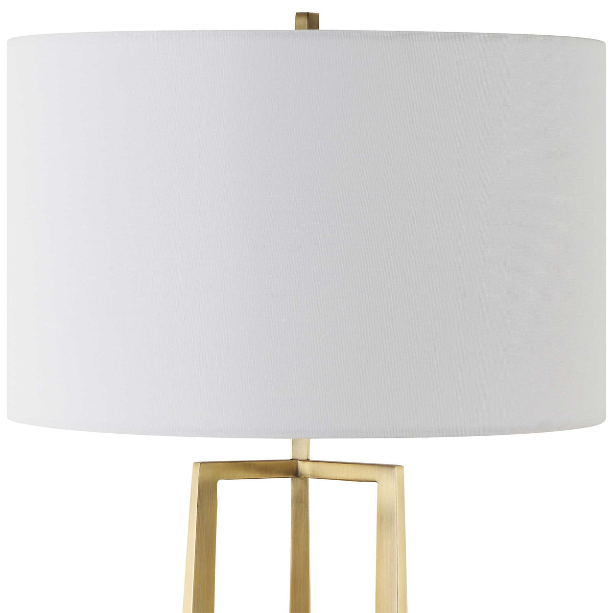 Close up of the 16 inch wide white linen drum shade on a gold and black nightstand lamp