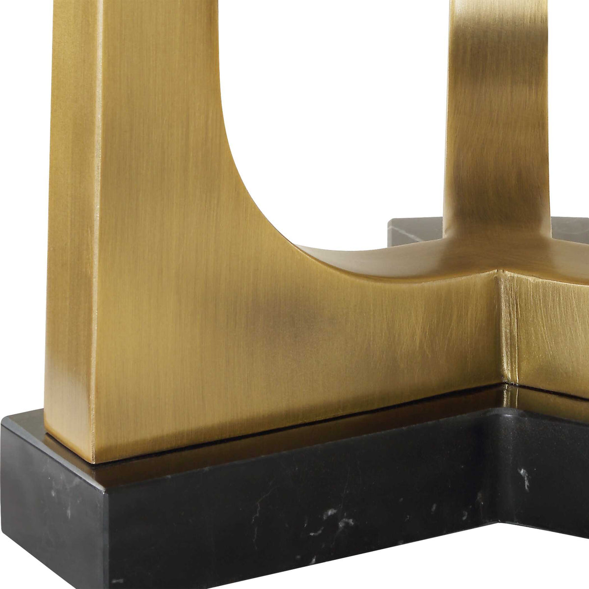Close up of the plated antique brass legs meeting the black marble base of a Dark Academia lamp