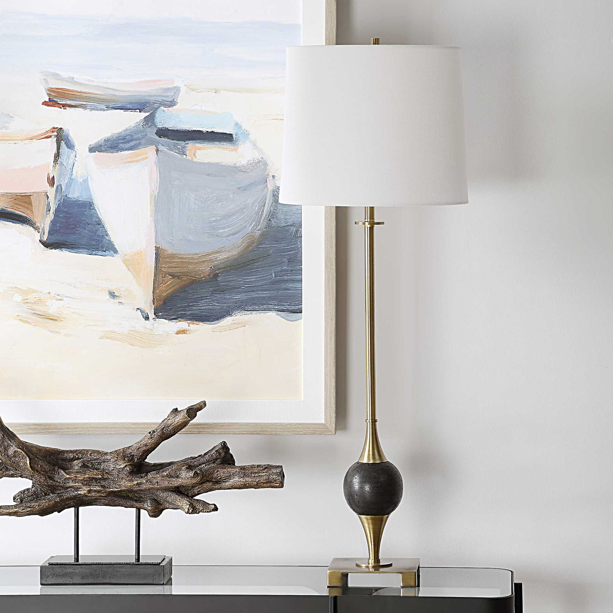Console lamp unlit on the same glass console, black dolomite marble orb on a slim plated brass stem, 35 inches tall