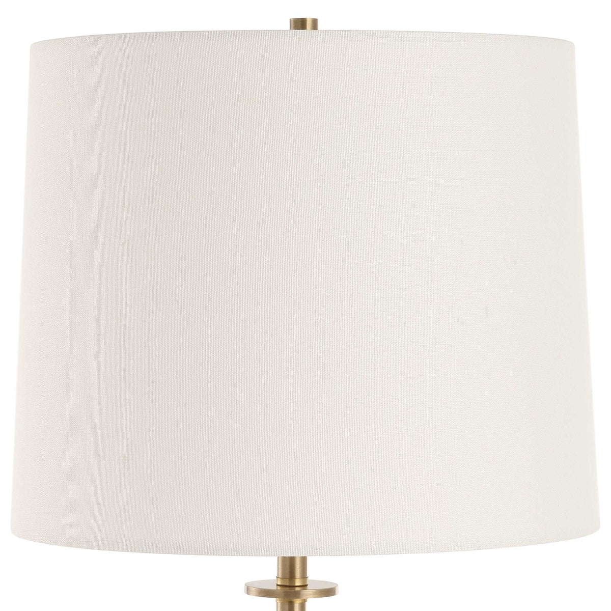 Close up of the white bell drum hardback shade with brass finial and collar on a brass and marble console lamp