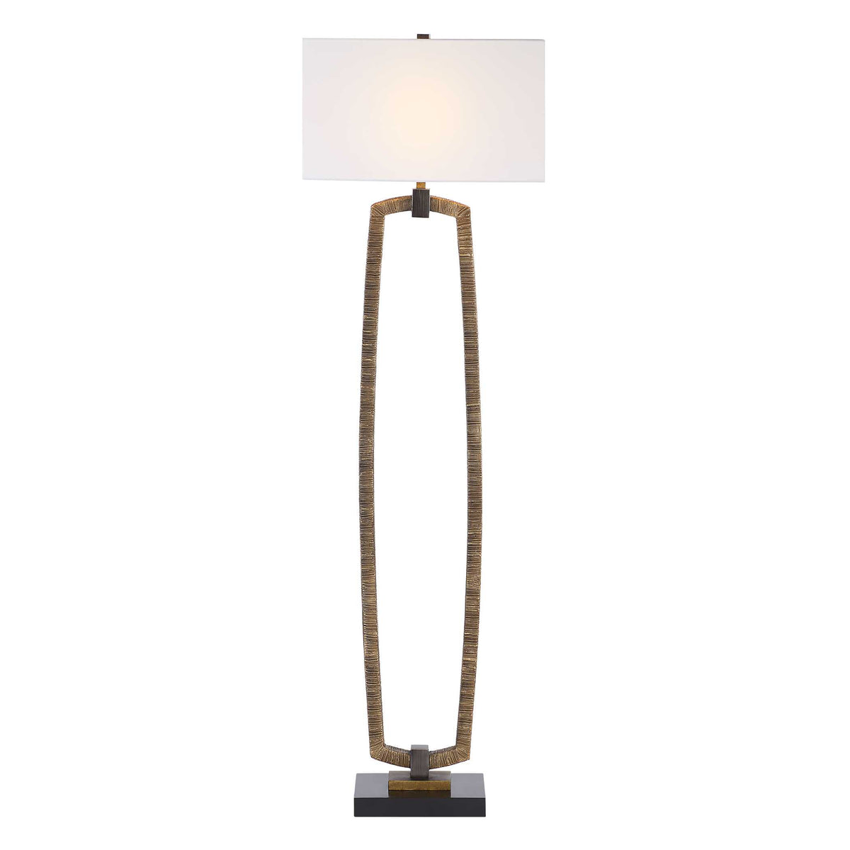 Open frame reading lamp in antiqued gold resin with glowing rectangular drum hardback shade