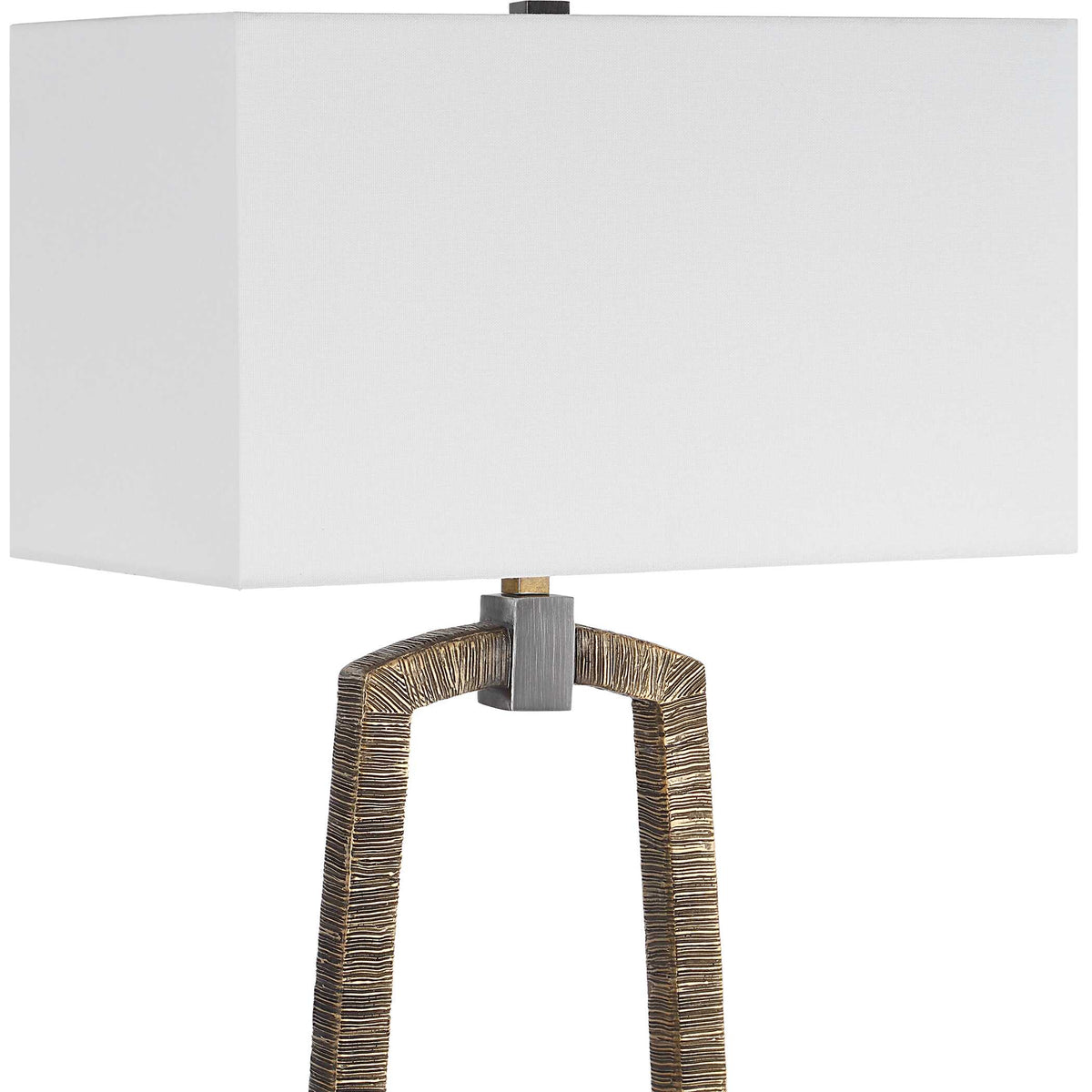 Close-up of the rectangular white linen shade and dark bronze collar at the top of the carved gold loop