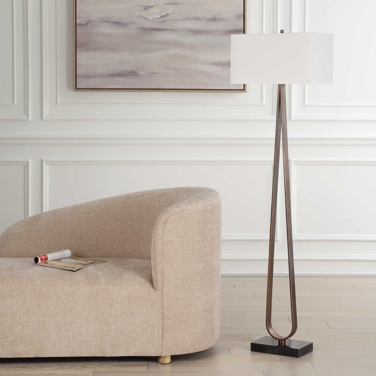 Slim Dark Bronze iron standing lamp with a rectangular drum shade next to a curved sofa