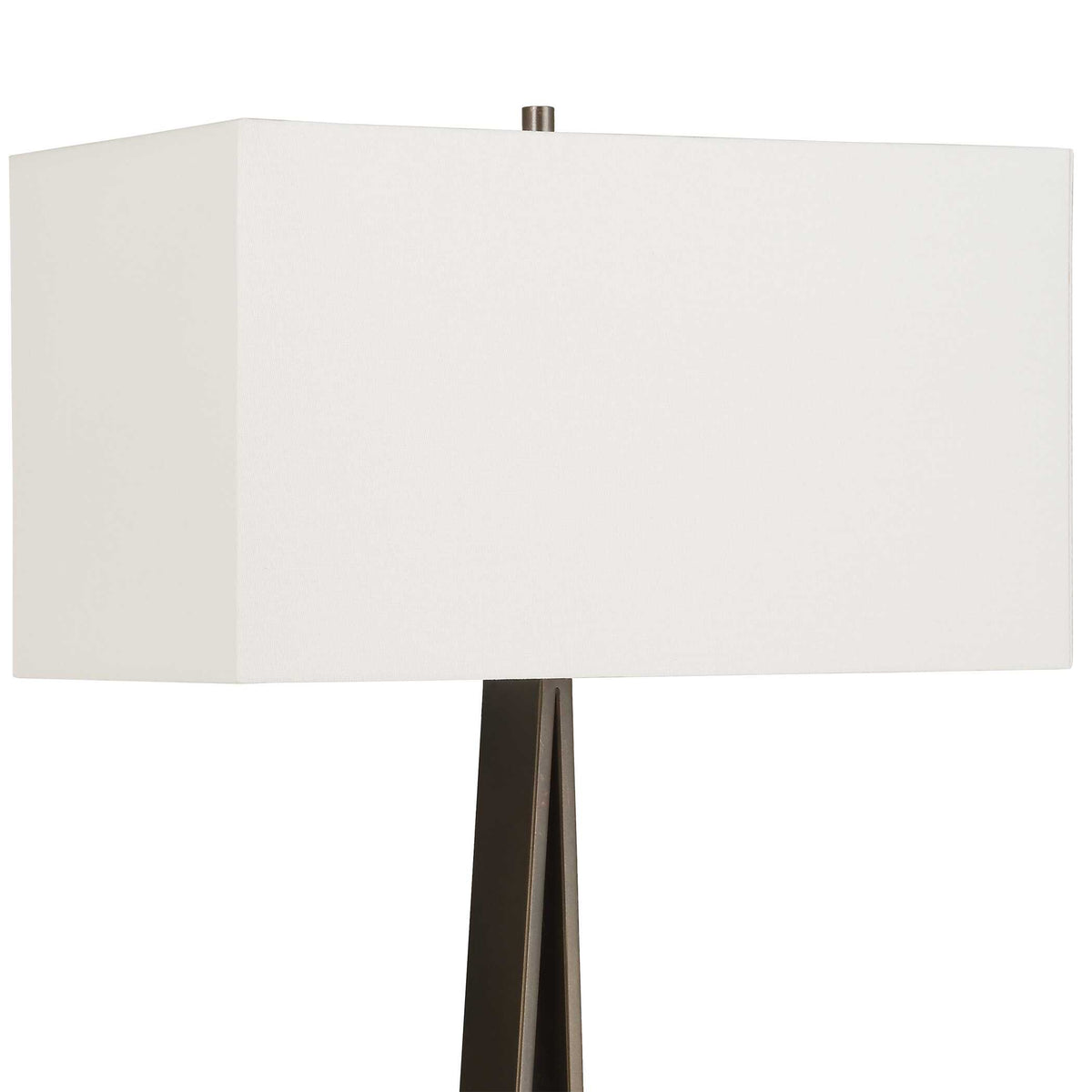 Close up of the white rectangular linen hardback shade and bronze finial on a living room floor lamp