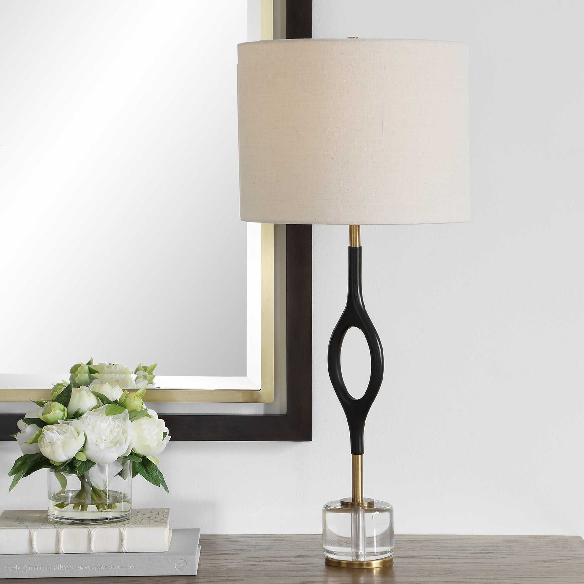 Maryam cordless buffet lamp on a wood console beneath a mirror beside white peonies