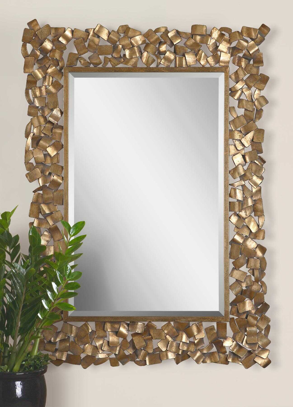 Uttermost 12816 Capulin antique gold mirror on a wall beside a potted plant