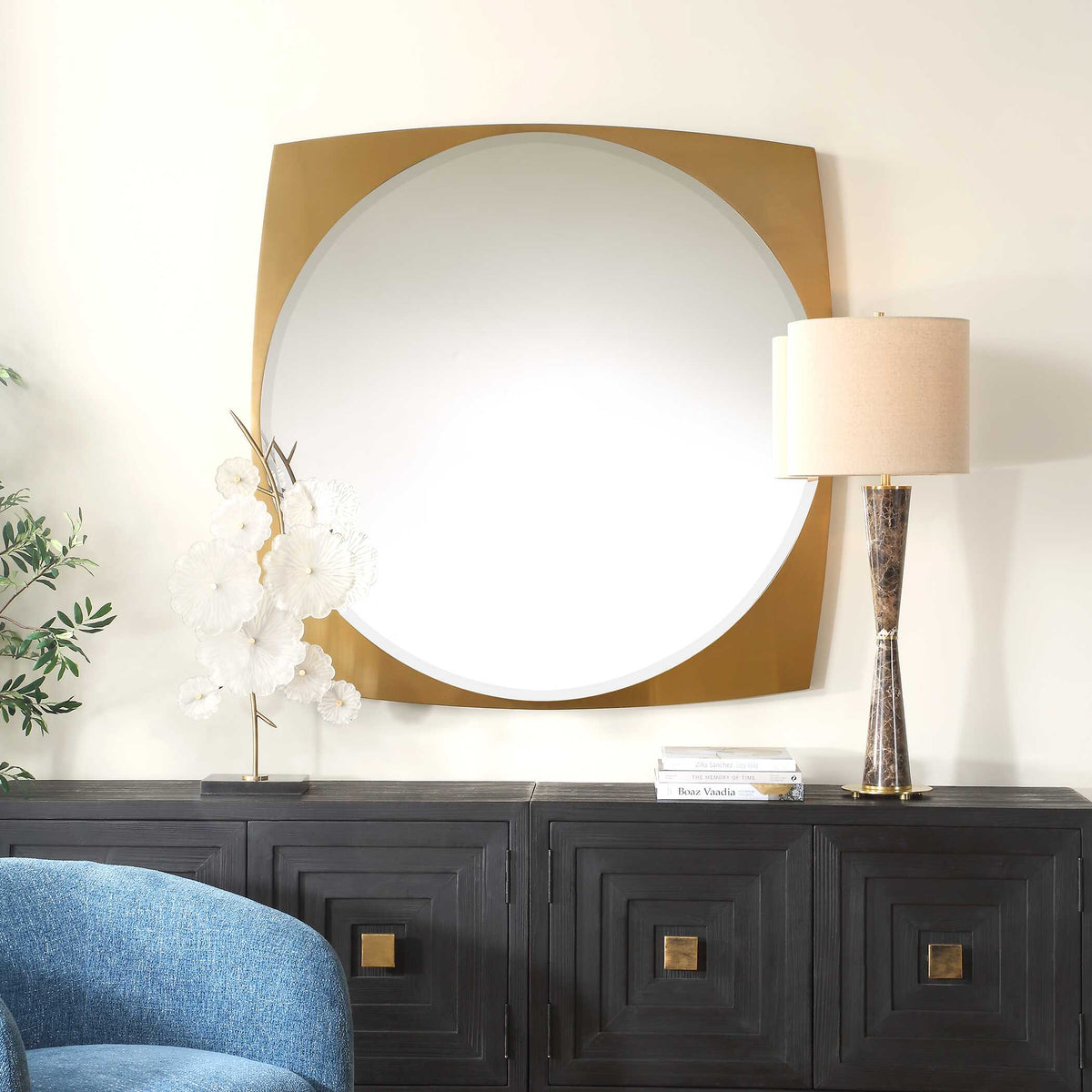 Uttermost 08264 Neilia collection mirror above a dark sideboard with a table lamp