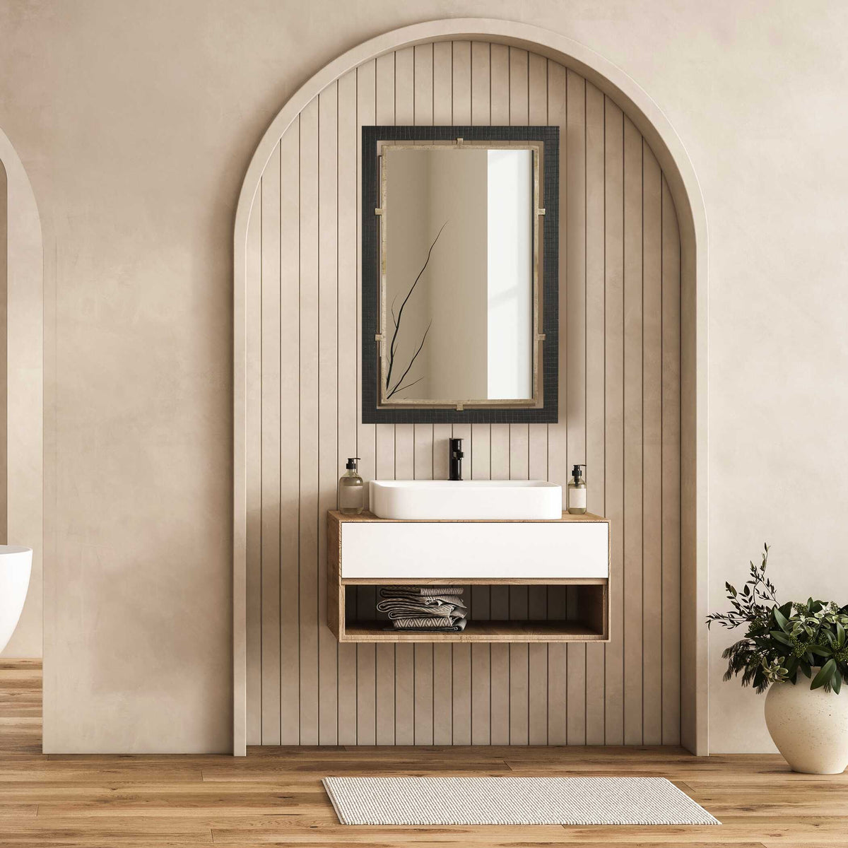 Uttermost 08336 Bach collection mirror above a floating vanity with a vessel sink in an arched niche