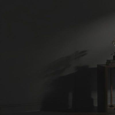 a short video of a dark room with a table, mirror, and decorative items.
