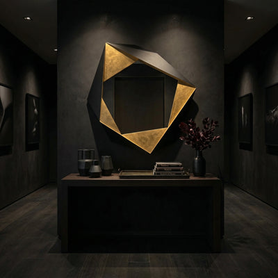 Short product video of Ambella Home Folded Mirror in black and gold, 48W x 5D x 49H geometric wall mirror above a dark credenza in a luxury hallway