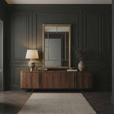 A short product video of Rochelle Pier Mirror by Ambella Home in vermeil finish, featuring two fluted columns, divided antique mirror frame panels, and a clear center mirror in a dark paneled room