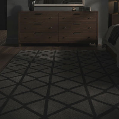 A short video of wooden dresser with a large mirror in a dimly lit room