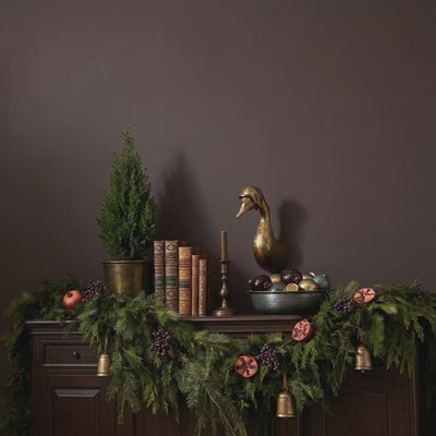 Product video of a Charlie the Duck aviator brass antique gold wall mount styled as gold-wall-decor above a holiday mantel with greenery