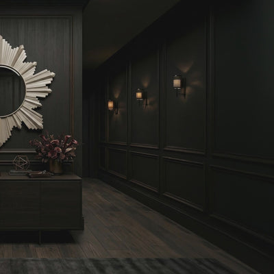 Short product video of Ambella Home Vassar Mirror in champagne finish, 37W x 2D x 40H sunburst wall mirror above a dark credenza in a luxury hallway