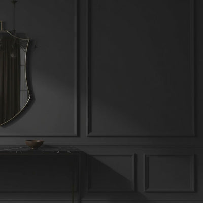 A short video of a decorative mirror on a dark wall with a console table below featuring sculptures and a bowl.